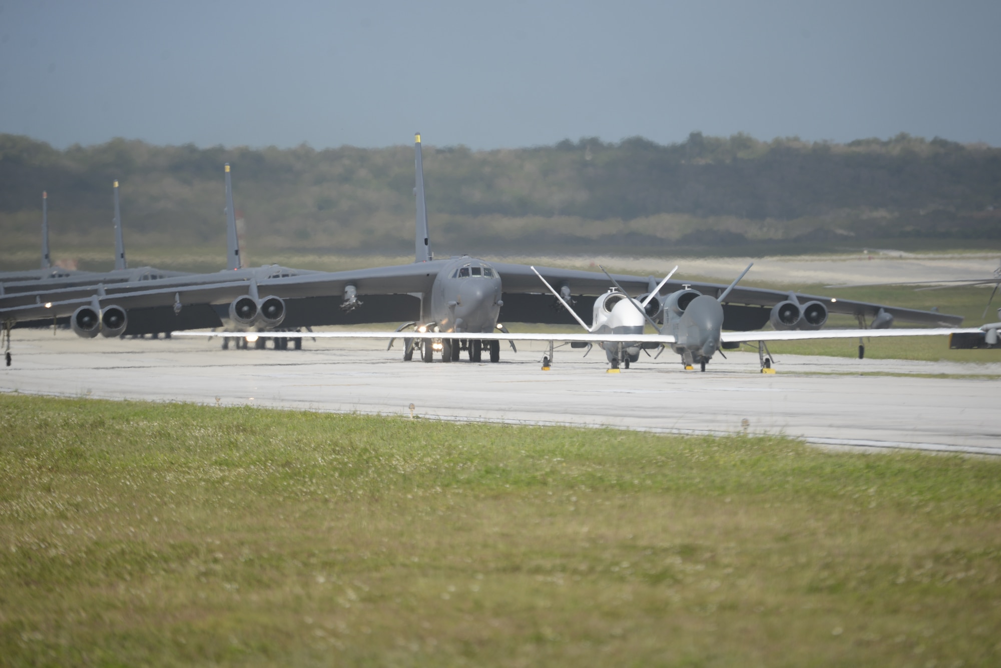 A U.S. Navy MH-60S Knighthawk, U.S. Air Force RQ-4 Global Hawk, Navy MQ-4C Triton, Air Force B-52 Stratofortresses, and KC-135 Stratotankers stationed at Andersen Air Force Base, Guam, perform an "Elephant Walk" April 13, 2020.