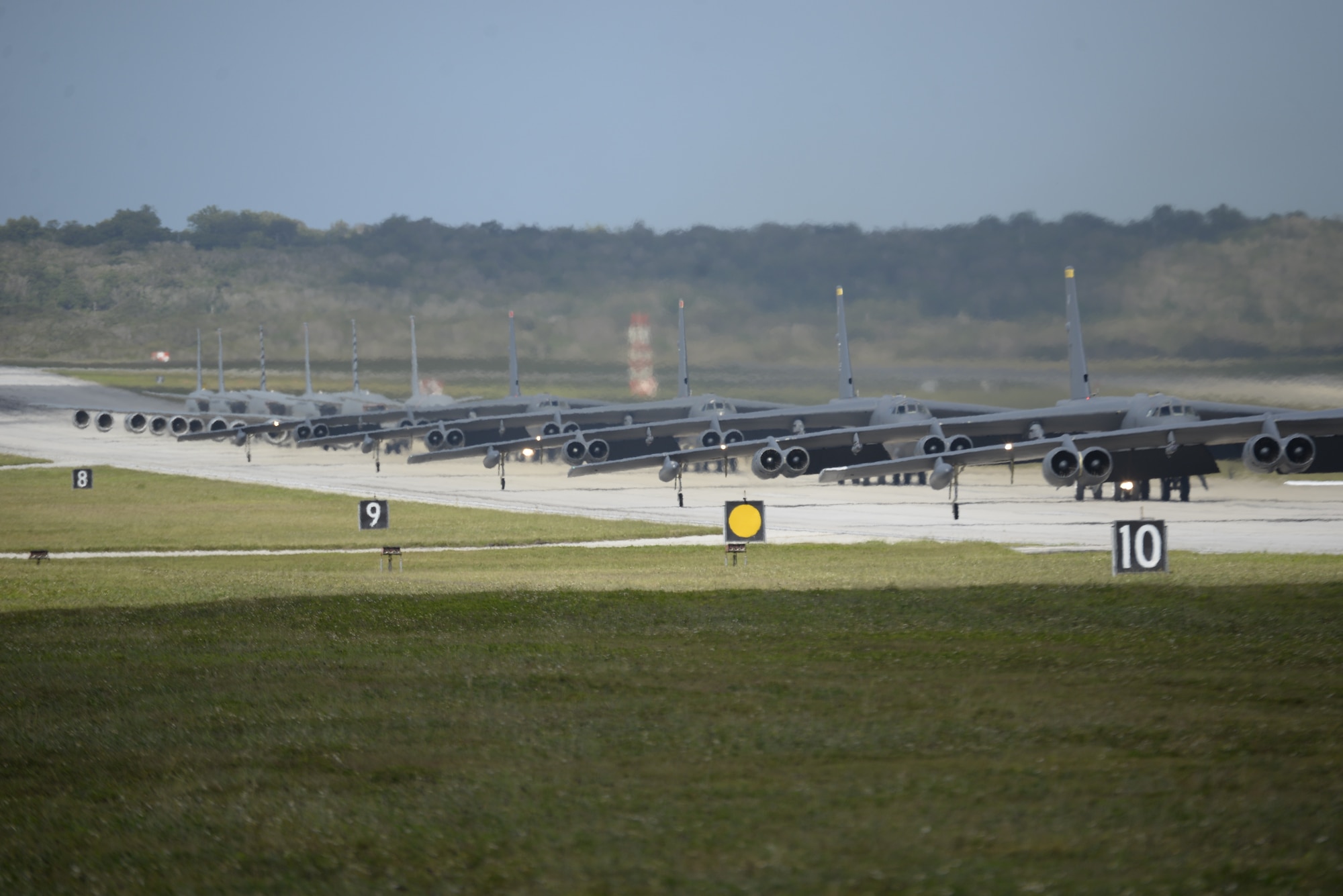 A U.S. Navy MH-60S Knighthawk, MQ-4C Triton, U.S. Air Force RQ-4 Global Hawk, B-52 Stratofortresses, and KC-135 Stratotankers stationed at Andersen Air Force Base, Guam, perform an "Elephant Walk" April 13, 2020.