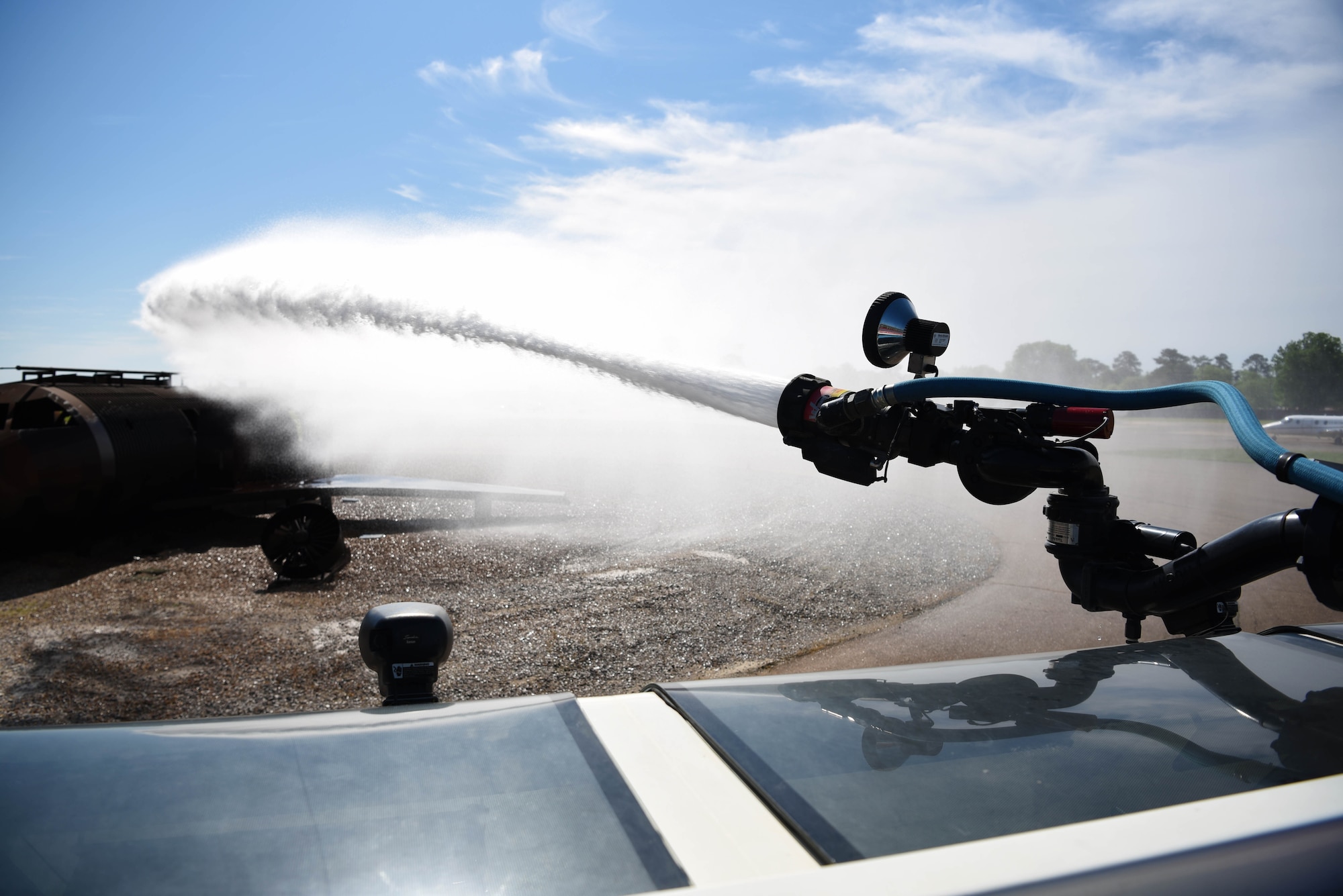 A Striker 1500 shoots out water toward an exercise aircraft model April 10, 2020, on Columbus Air Force Base, Miss. Columbus Air Force Base Fire and Emergency Services is tasked with mitigation and incident management for fire, aircraft, hazardous material, medical and other emergencies. (U.S. Air Force photo by Airman 1st Class Jake Jacobsen)