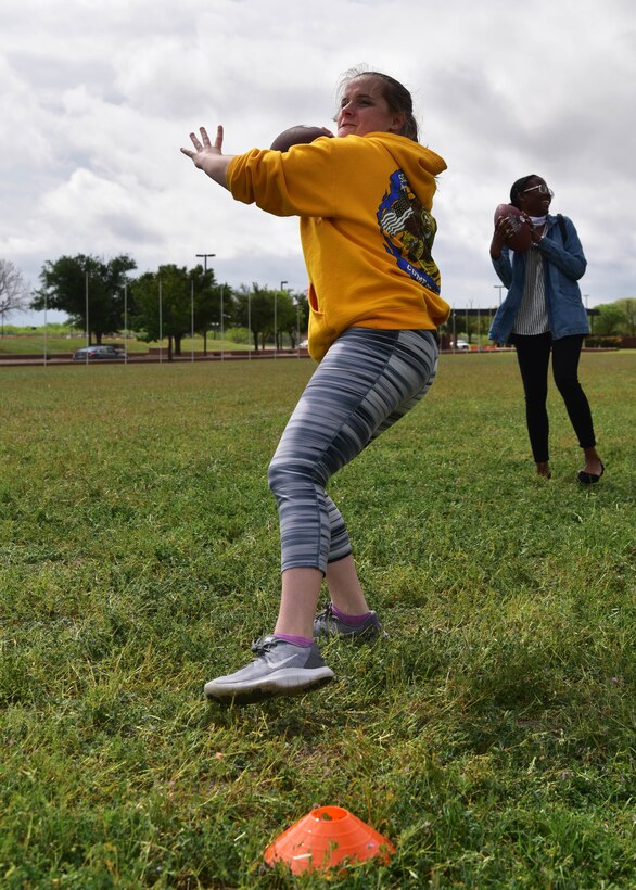 A team of Airmen competes in the football punt, pass and kick portion of the ‘Break the Pandemic’ Morale event on Goodfellow Air Force Base, Texas, April 11, 2020. The 315th Training Squadron hosted the event, in which teams competed in eight different physical and mental challenges in order to escape the monotony of social distancing regulations in response to the COVID-19 pandemic. (U.S. Air Force photo by Staff Sgt. Chad Warren)