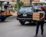 A first sergeant carries a stack of pizzas during a drive-thru dinner give-away event in Las Vegas, Nevada.