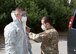 Soldiers and Airmen from the Massachusetts National Guard don proper personal protective equipment (PPE)