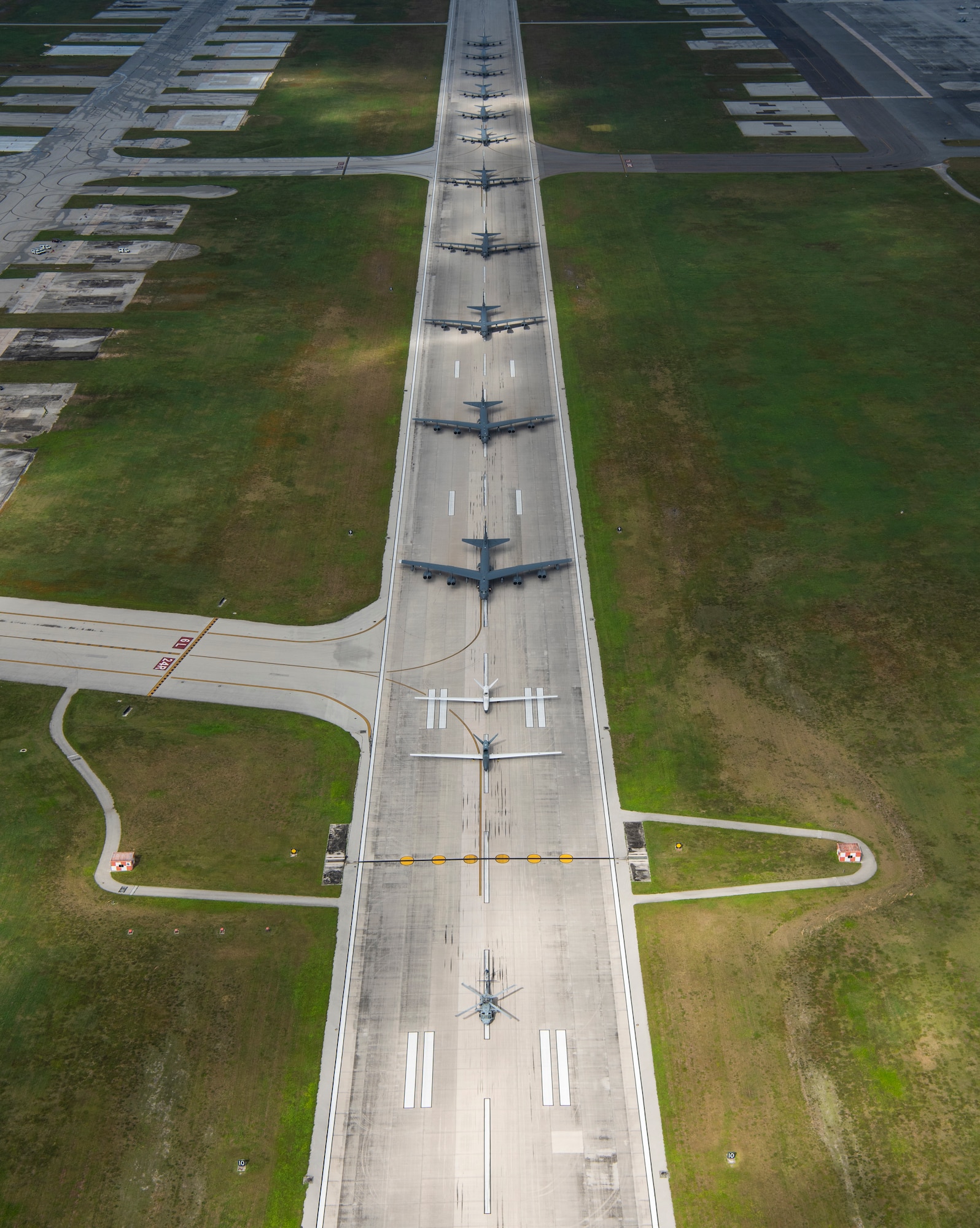 A U.S. Navy MH-60S Knighthawk, U.S. Air Force RQ-4 Global Hawk, Navy MQ-4C Triton, Air Force B-52 Stratofortress’, and KC-135 Stratotankers stationed at Andersen Air Force Base, Guam, perform an "Elephant Walk" April 13, 2020.