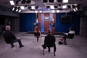 Defense Secretary Dr. Mark T. Esper and Army Gen. Mark A. Milley stand at lecterns in front of a few seated civilians.