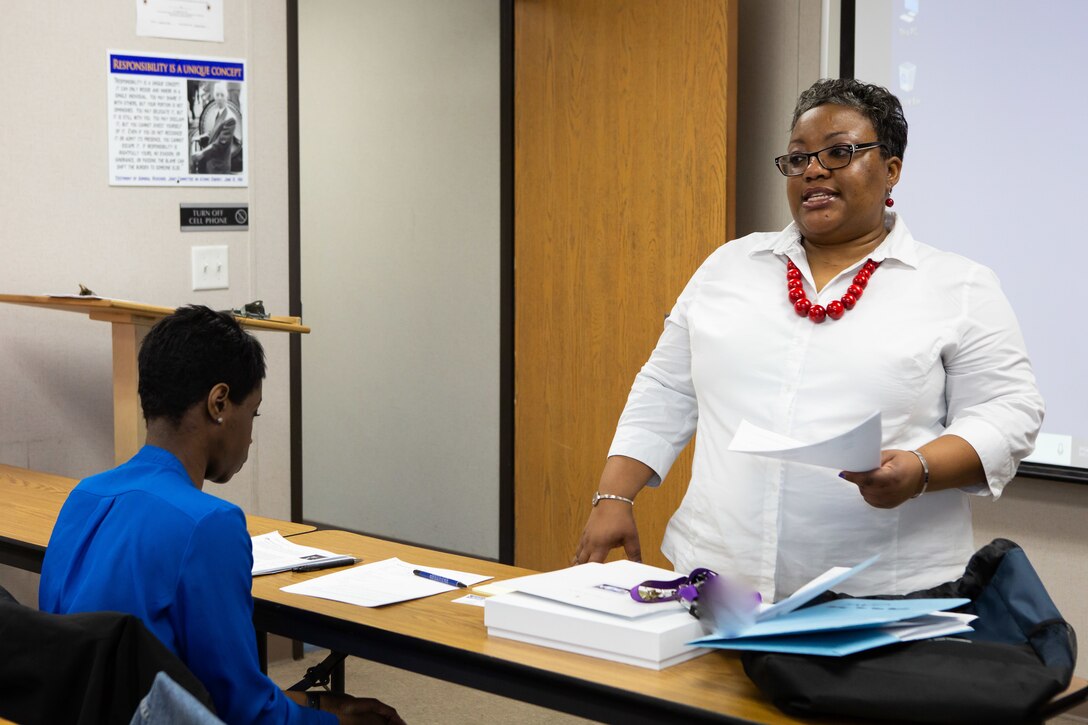 Norfolk Naval Shipyard's Federal Women’s Program Chairperson Carlynn Lucas discusses the agenda for a FWP monthly meeting Mar. 14.