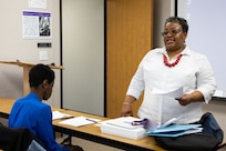 Norfolk Naval Shipyard's Federal Women’s Program Chairperson Carlynn Lucas discusses the agenda for a FWP monthly meeting Mar. 14.