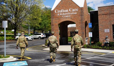 Maryland National Guard members led by Col. Eric Allely, Maryland State Surgeon, arrive at Crofton Care & Rehabilitation Center in Crofton, Maryland, April 9, 2020, to evaluate measures to protect against the spread of COVID-19.