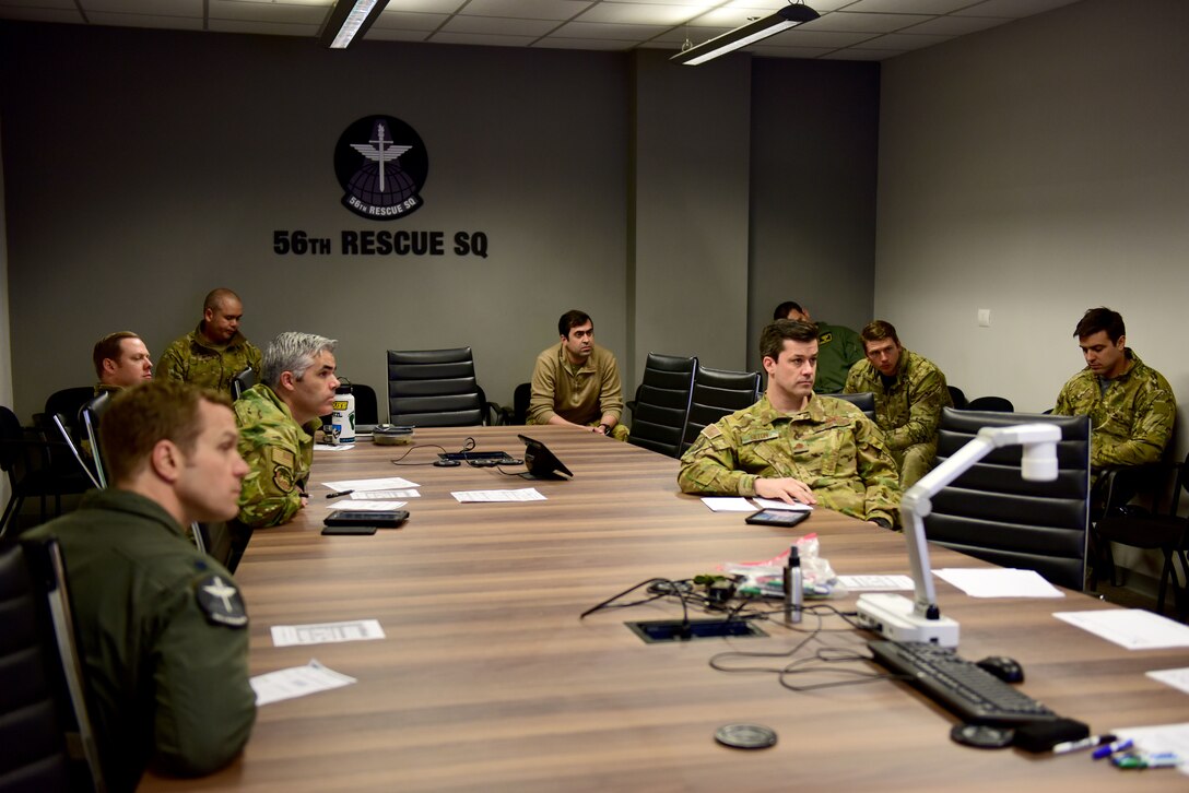 U.S. Airmen assigned to the 56th and 57th Rescue Squadrons attend a pre-mission briefing at Aviano Air Base, Italy, April 2, 2020. The 31st Fighter Wing is dedicated to continuing the mission, remaining lethal and rapidly ready while operating within the confines of decrees set by the Italian government to slow the spread of COVID-19. (U.S. Air Force photo by Staff Sgt. Kelsey Tucker)