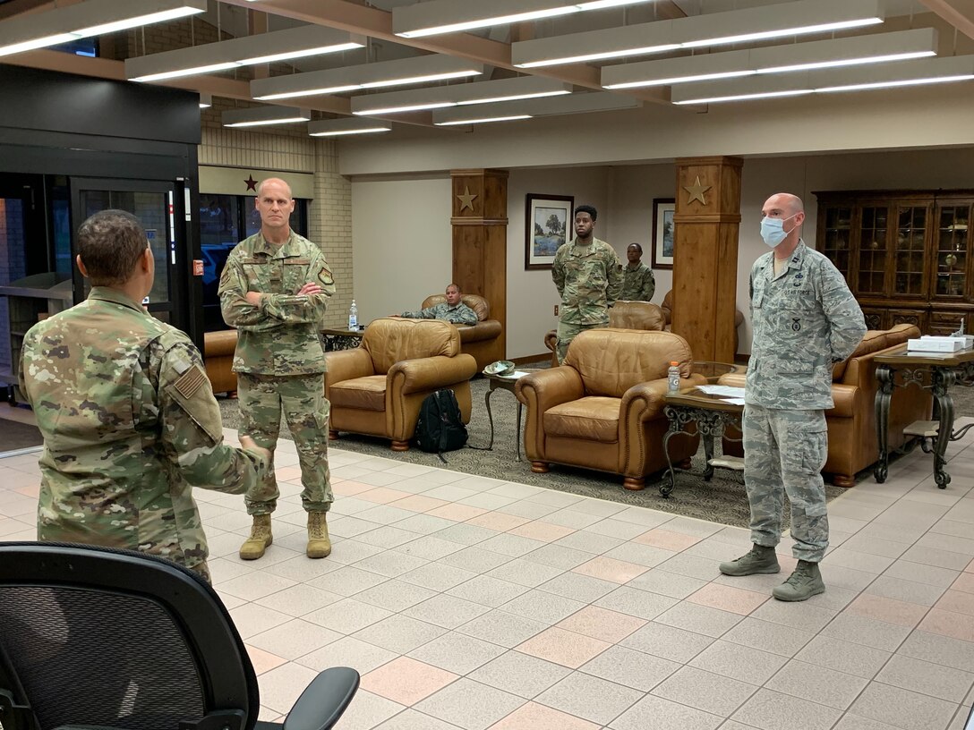 U.S. Air Force Col. Steven Anderson, 688th Cyberspace Wing commander, Chief Master Sgt. Israel Jaeger, 688th Cyberspace Wing Command Chief, Capt. Nathan Spradley, 502nd Air Base Wing, Master Sgt. Stephanie Russ, 323rd Training Squadron, and Staff Sgt. Ryan Owen, 67th Operations Support Squadron, volunteer for charge of quarters duty in support of Basic Military Training Airmen overnight Tuesday, April 7, 2020, Joint Base San Antonio – Lackland, Texas. CQ duties include intake, tracking and reporting, wellness checks, meal and personal item delivery, and arranging transport upon release. (U.S. Air Force photo by Chief Master Sgt. Israel Jaeger)