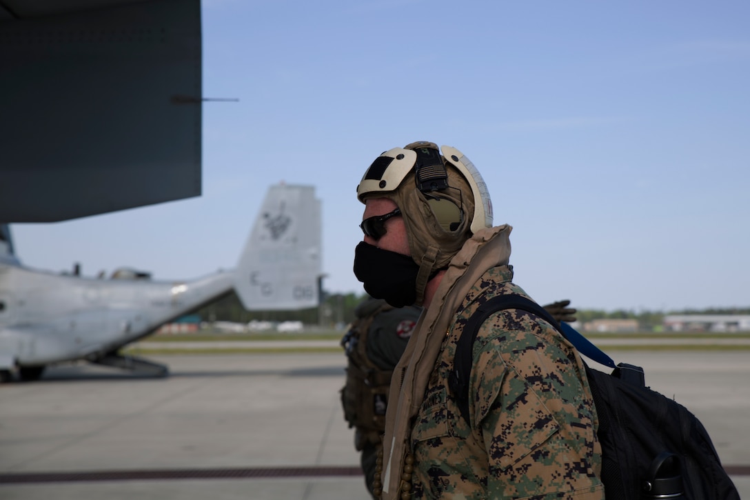 A U.S. Marine boards an MV-22B Osprey as they prepare for takeoff from the flight line at Marine Corps Air Station New River, N.C., April 10.