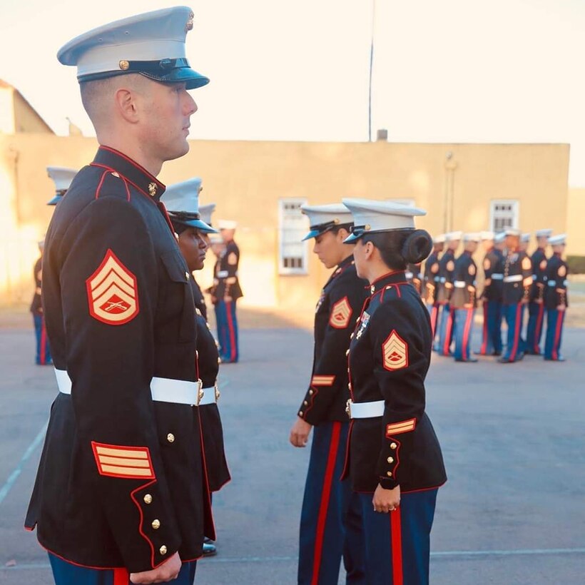 Students are being inspected to ensure proper fit of their Dress Blues.