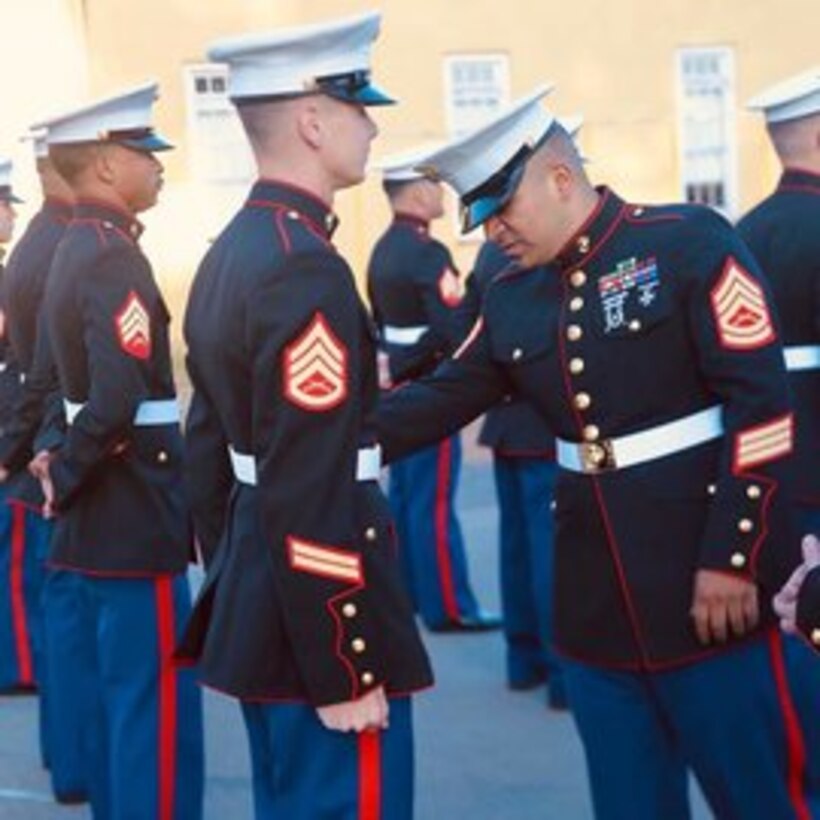 Students are inspected to ensure proper fit of their Dress Blues