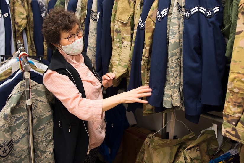 Kum Sun Yun, the manager of Stripes Alterations Shop, sorts through uniforms at Joint Base Charleston, S.C., April 7, 2020. Employees at Stripes Alterations Shop are taking safety precautions such as wearing masks, cleaning work areas and washing their hands frequently. The hours of operation for alterations are from 9 a.m. to 5 p.m. Monday through Friday and 9 a.m. to 3 p.m. on Saturdays.