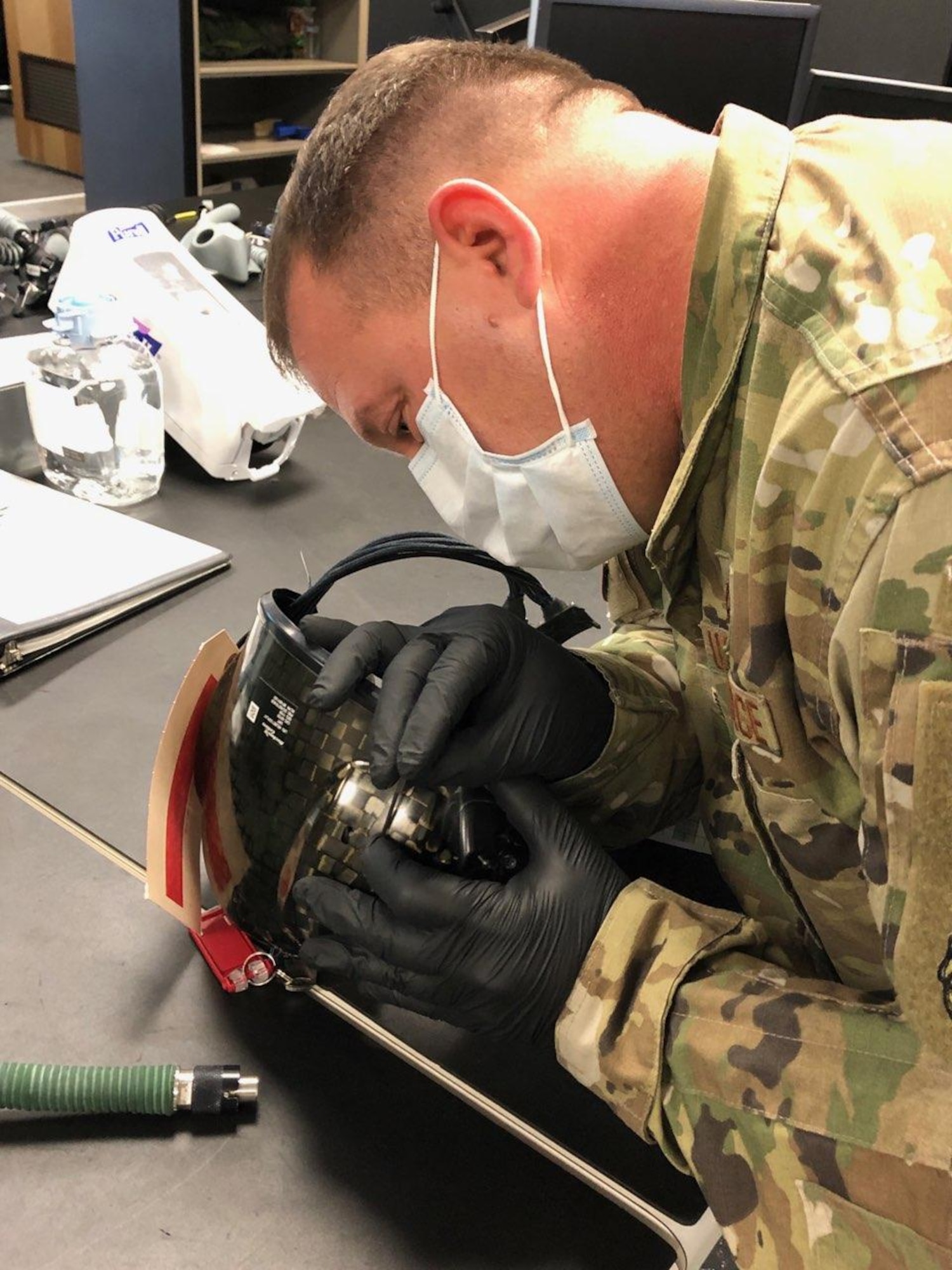 Tech. Sgt. William Vass from the Aircrew Flight Equipment shop in the 419th Operations Support Squadron processes a damaged Helmet Display Unit for supply turn-in.