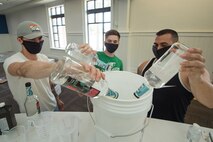 From left to right, Staff Sgt. Devan Trammel, 628th Civil Engineer Squadron explosive ordnance disposal flight team leader, Senior Airman Jacob Smith, 437th Maintenance Squadron aircraft hydraulics journeyman, and Tech. Sgt. Austin Barkdoll, 373rd Training Squadron, Detachment 5 instructor element NCOIC, all Palmetto Spark innovation lab members, prepare ingredients to produce hand sanitizer in an effort to support mission essential personnel and combat health risks associated with the COVID-19 pandemic, at Joint Base Charleston, S.C., April 10, 2020. The innovation team, Palmetto Spark, is comprised of Airmen from across JB Charleston. Their mission is to enable Airmen to solve problems they face day-to-day.