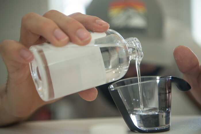 Staff Sgt. Devan Trammel, 628th Civil Engineer Squadron explosive ordnance disposal flight team leader and Palmetto Spark innovation lab member, prepares ingredients to produce hand sanitizer in an effort to support mission essential personnel and combat health risks associated with the COVID-19 pandemic, at Joint Base Charleston, S.C., April 10, 2020. The innovation team, Palmetto Spark, is comprised of Airmen from across JB Charleston. Their mission is to enable Airmen to solve problems they face day-to-day.
