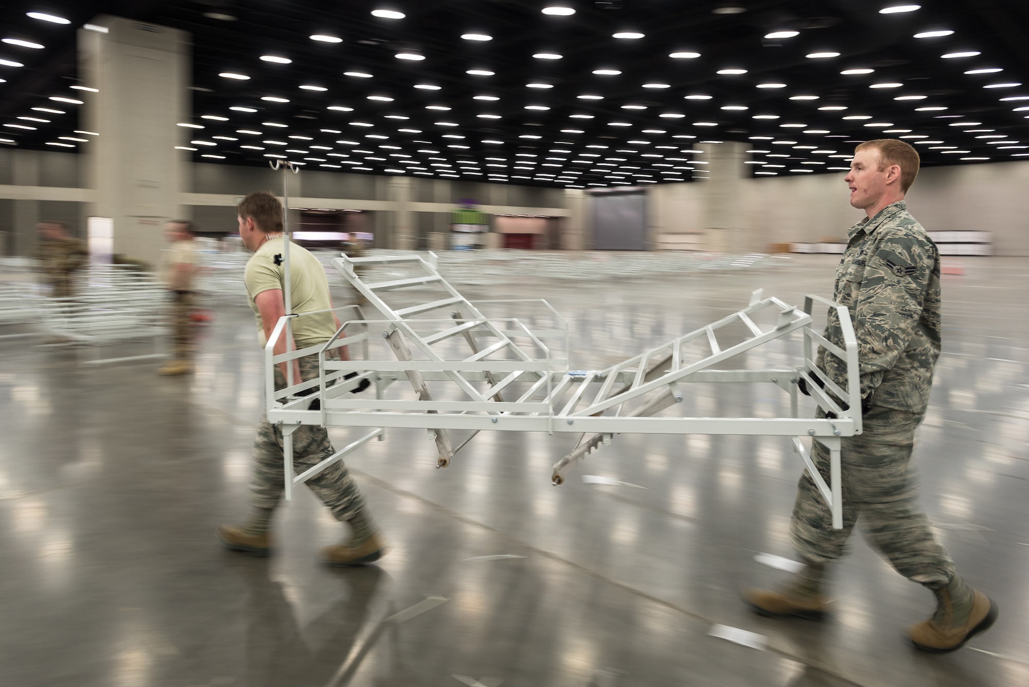 More than 30 members of the Kentucky Air National Guard’s 123rd Civil Engineer Squadron set up hospital beds and clinical space at the Kentucky Fair and Exposition Center in Louisville, Ky., April 11, 2020. The site, which is expected to be operational April 15, will serve as an Alternate Care Facility for patients suffering from COVID-19 if area hospitals exceed available capacity. The location initially can treat up to 288 patients and is scalable to 2,000 beds. (U.S. Air National Guard photo by Dale Greer)