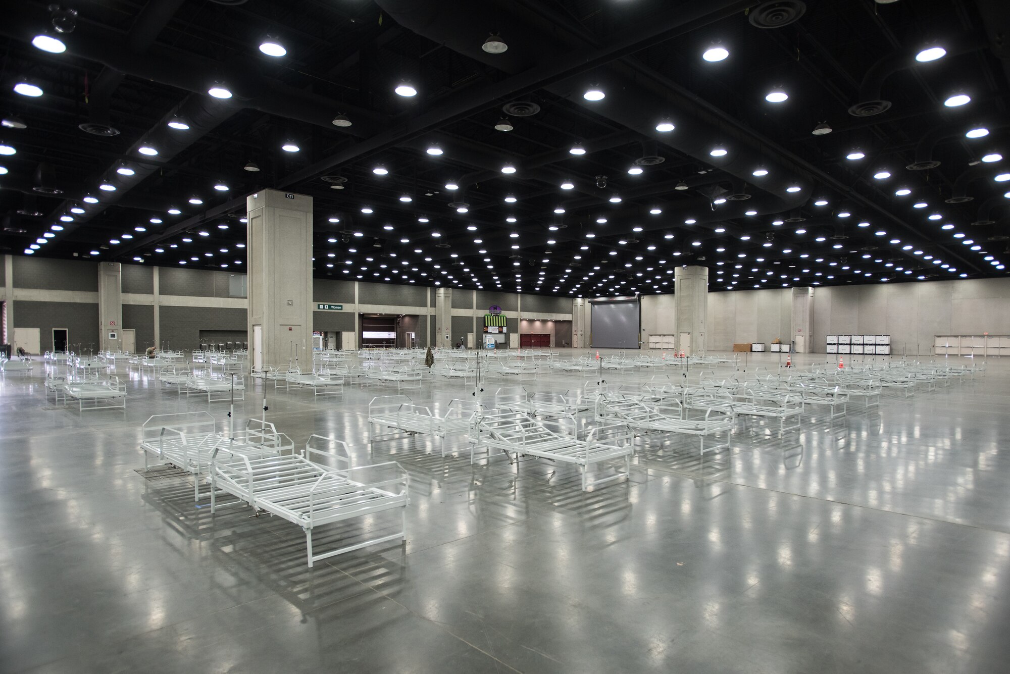 More than 30 members of the Kentucky Air National Guard’s 123rd Civil Engineer Squadron set up hospital beds and clinical space at the Kentucky Fair and Exposition Center in Louisville, Ky., April 11, 2020. The site, which is expected to be operational April 15, will serve as an Alternate Care Facility for patients suffering from COVID-19 if area hospitals exceed available capacity. The location initially can treat up to 288 patients and is scalable to 2,000 beds. (U.S. Air National Guard photo by Dale Greer)