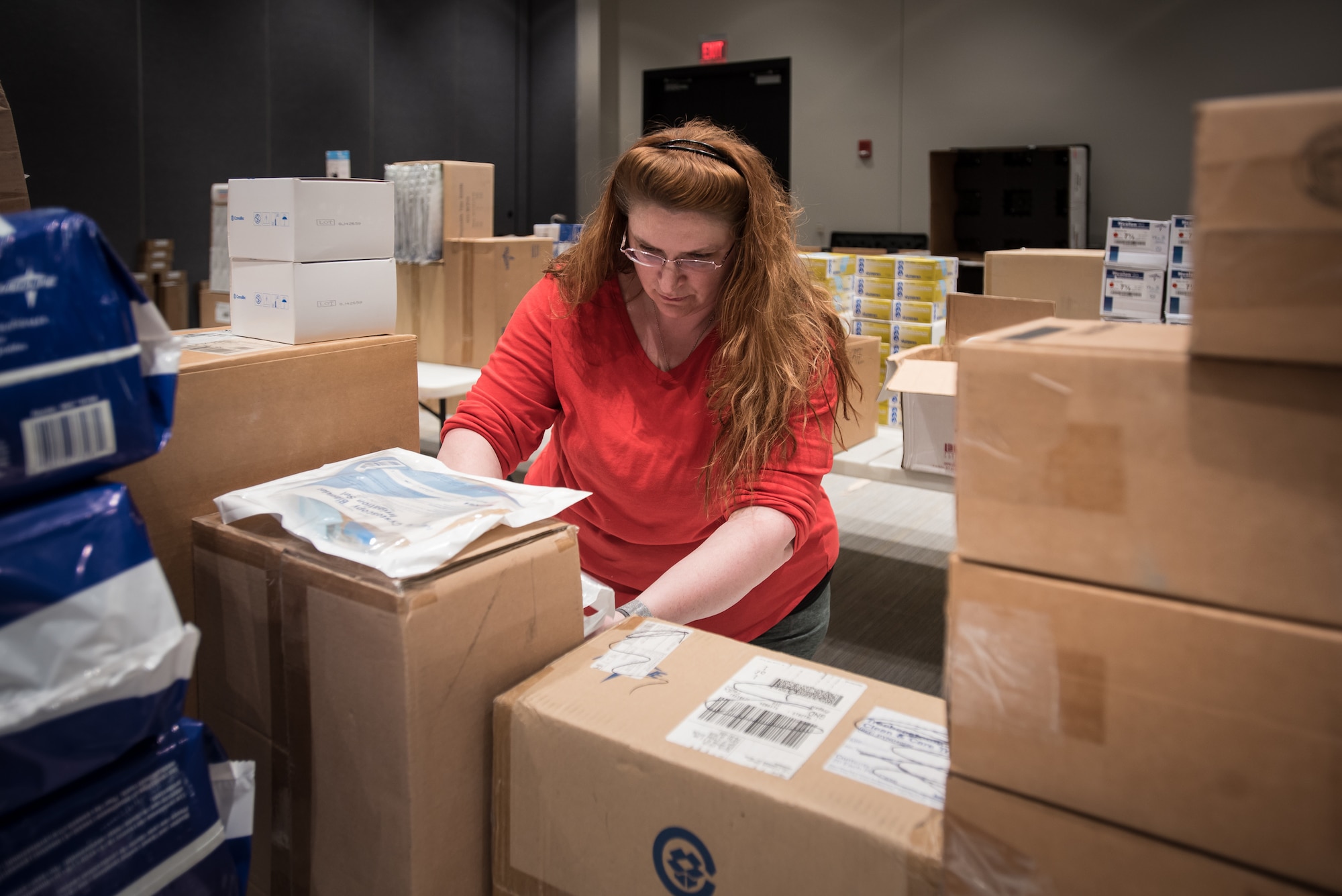 Margaret Hibbs, a regional preparedness coordinator for the Kentucky Department of Public Health, sorts medical supplies at the Kentucky Fair and Exposition Center in Louisville, Ky., April 11, 2020. The site will serve as an Alternate Care Facility for patients suffering from COVID-19 if area hospitals exceed available capacity. The location initially can treat up to 288 patients and is scalable to 2,000 beds. (U.S. Air National Guard photo by Dale Greer)