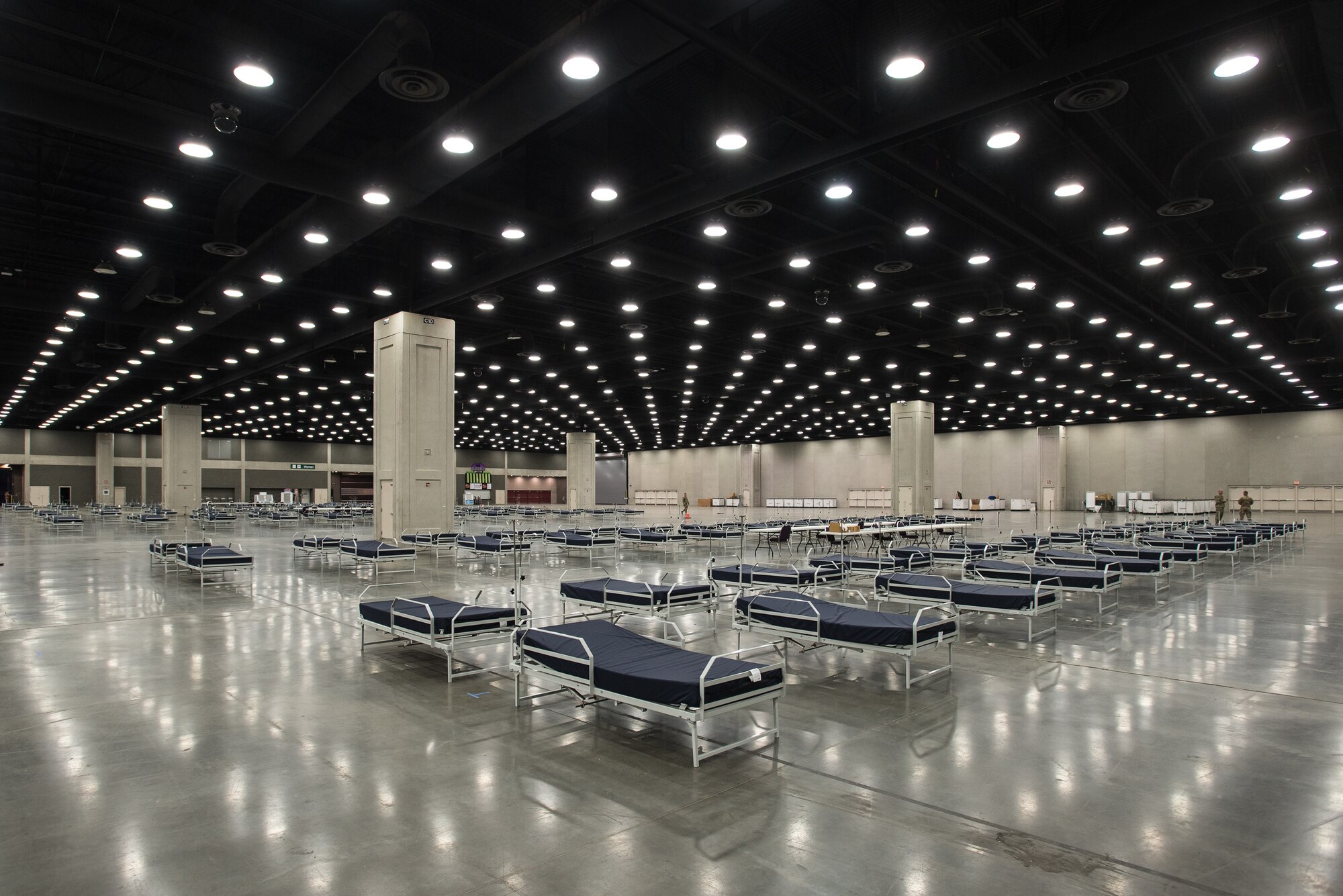 More than 30 members of the Kentucky Air National Guard’s 123rd Civil Engineer Squadron set up hospital beds and clinical space at the Kentucky Fair and Exposition Center in Louisville, Ky., April 13, 2020. The site, which is expected to be operational April 15, will serve as an Alternate Care Facility for patients suffering from COVID-19 if area hospitals exceed available capacity. The location initially can treat up to 288 patients and is scalable to 2,000 beds. (U.S. Air National Guard photo by Dale Greer)