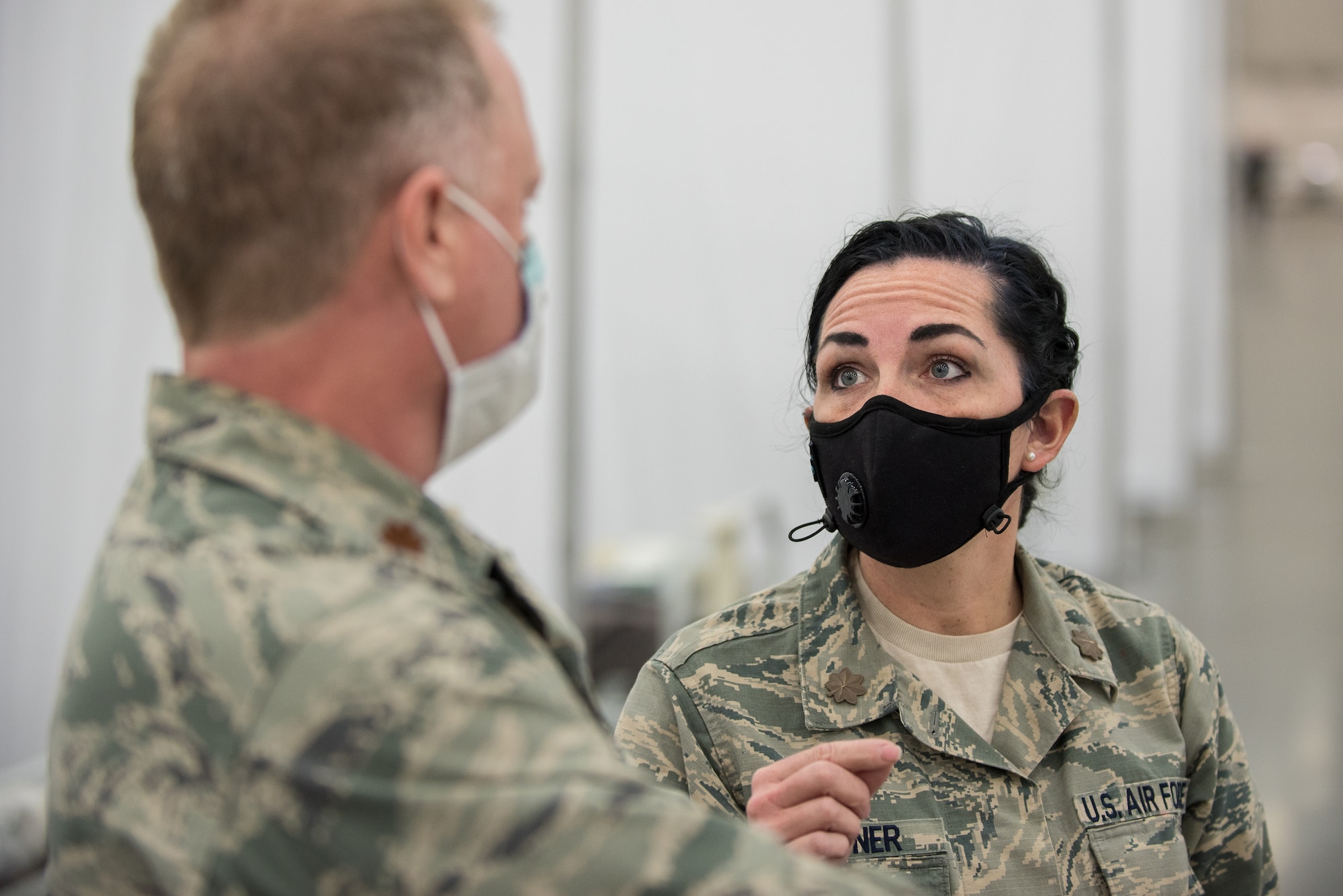 Maj. Rebekah Stenger (right), a nurse in the Kentucky Air National Guard’s 123rd Medical Group Detachment 1, consults with Maj. Anthony Gardner, a nurse from the same unit, during the set-up of an Alternate Care Facility at the Kentucky Fair and Exposition Center in Louisville, Ky., April 14, 2020. The site, which is expected to be operational April 15, will serve patients suffering from COVID-19 if area hospitals exceed available capacity. The facility initially will offer care for up to 288 patients and is scalable to 2,000 beds. (U.S. Air National Guard photo by Dale Greer)