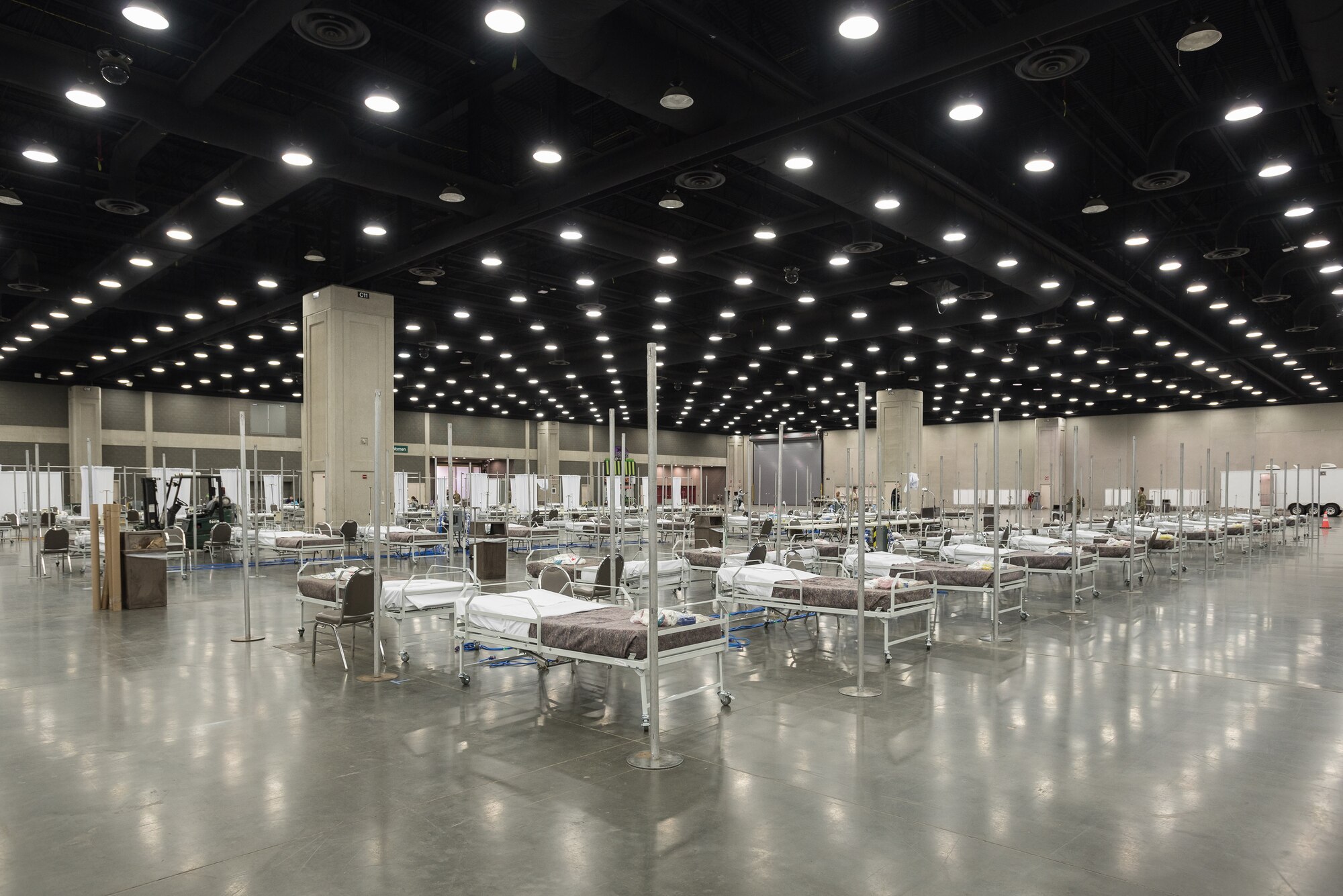 More than 30 members of the Kentucky Air National Guard’s 123rd Civil Engineer Squadron set up hospital beds and clinical space at the Kentucky Fair and Exposition Center in Louisville, Ky., April 14, 2020. The site, which is expected to be operational April 15, will serve as an Alternate Care Facility for patients suffering from COVID-19 if area hospitals exceed available capacity. The location initially can treat up to 288 patients and is scalable to 2,000 beds. (U.S. Air National Guard photo by Dale Greer)