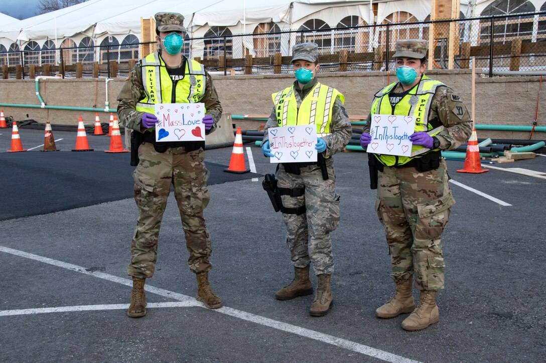 Airmen and Soldiers of the Massachusetts National Guard take a photo they respond together to help their communities during the COVID-19 response. Security Forces Airmen from the 104th Fighter Wing, Barnes Air National Guard Base, Mass., and Soldiers with the 747th Military Police Company, Massachusetts Army National Guard, are providing 24-hour security for testing sites and shelters for the homeless who may be positive COVID-19. The Airmen and Soldiers are working with interagency partners Springfield Police Department to ensure security and safety for the supplies, patients, and staff. Massachusetts National Guard units were activated at the request of Governor Charlie Baker and are helping at the testing facilities as a joint-task force. (Left to Right: Spc. Haley MacDonald and Spc. Alan Navarro) (U.S. Air National Guard Photo by Senior Master Sgt. Julie Avey)