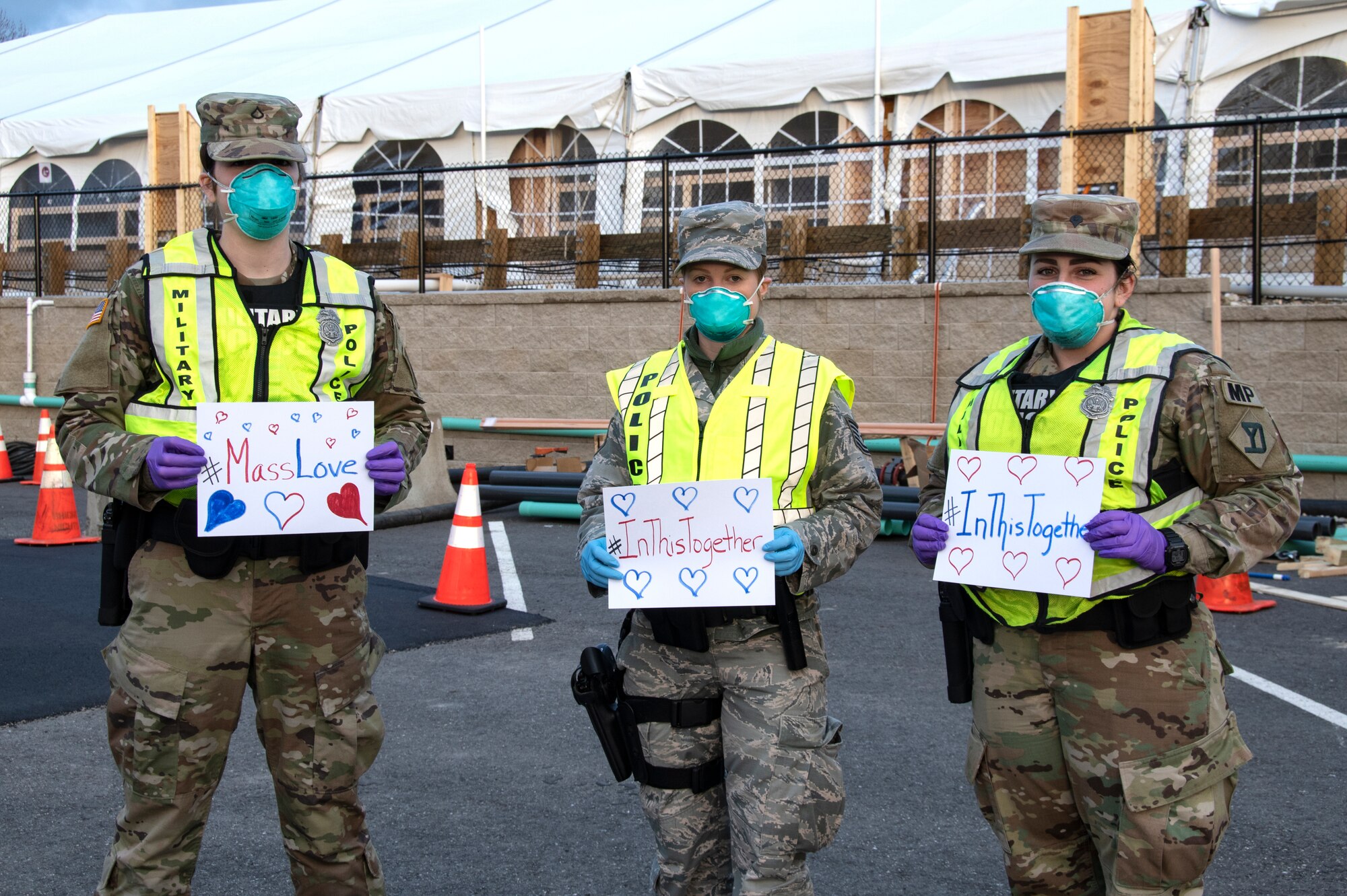 Airmen and Soldiers of the Massachusetts National Guard take a photo they respond together to help their communities during the COVID-19 response. Security Forces Airmen from the 104th Fighter Wing, Barnes Air National Guard Base, Mass., and Soldiers with the 747th Military Police Company, Massachusetts Army National Guard, are providing 24-hour security for testing sites and shelters for the homeless who may be positive COVID-19. The Airmen and Soldiers are working with interagency partners Springfield Police Department to ensure security and safety for the supplies, patients, and staff. Massachusetts National Guard units were activated at the request of Governor Charlie Baker and are helping at the testing facilities as a joint-task force. (Left to Right: Spc. Haley MacDonald and Spc. Alan Navarro) (U.S. Air National Guard Photo by Senior Master Sgt. Julie Avey)