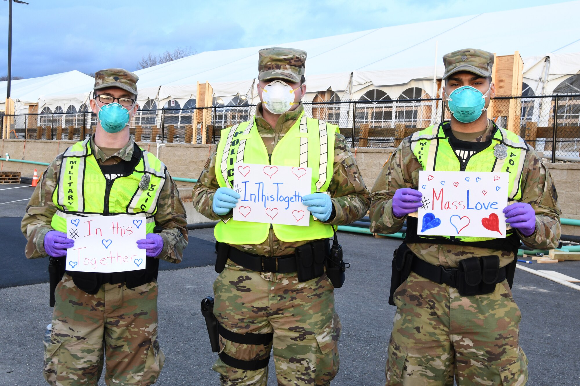 Airmen and Soldiers of the Massachusetts National Guard take a photo they respond together to help their communities during the COVID-19 response. Security Forces Airmen from the 104th Fighter Wing, Barnes Air National Guard Base, Mass., and Soldiers with the 747th Military Police Company, Massachusetts Army National Guard, are providing 24-hour security for testing sites and shelters for the homeless who may be positive COVID-19. The Airmen and Soldiers are working with interagency partners Springfield Police Department to ensure security and safety for the supplies, patients, and staff. Massachusetts National Guard units were activated at the request of Governor Charlie Baker and are helping at the testing facilities as a joint-task force. (Left to Right: Spc. Haley MacDonald and Spc. Alan Navarro) (U.S. Air National Guard Photo by Senior Master Sgt. Julie Avey)