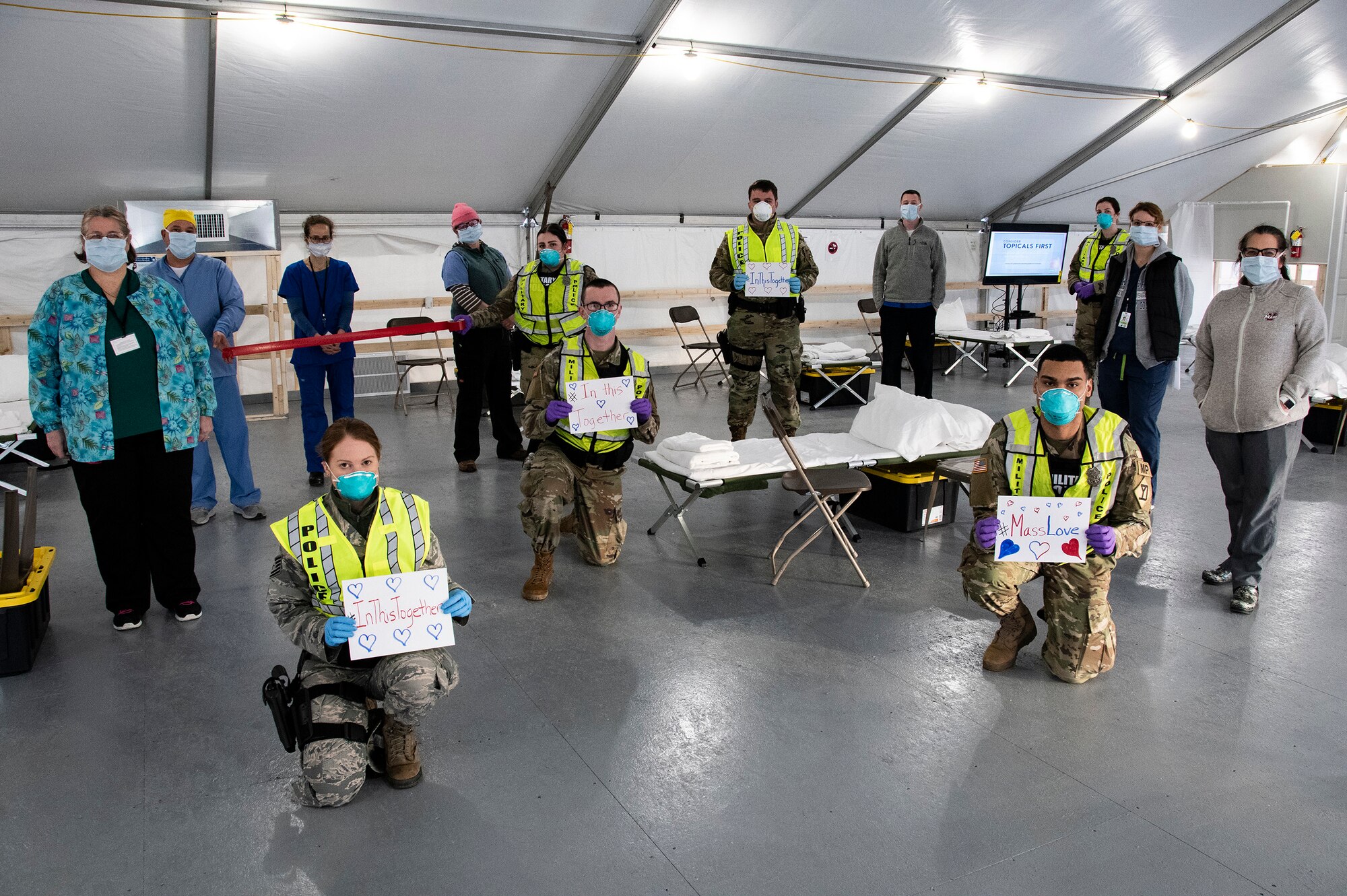 Airmen and Soldiers of the Massachusetts National Guard take a photo they respond together to help their communities during the COVID-19 response. Security Forces Airmen from the 104th Fighter Wing, Barnes Air National Guard Base, Mass., and Soldiers with the 747th Military Police Company, Massachusetts Army National Guard, are providing 24-hour security for testing sites and shelters for the homeless who may be positive COVID-19. The Airmen and Soldiers are working with interagency partners Springfield Police Department to ensure security and safety for the supplies, patients, and staff. Massachusetts National Guard units were activated at the request of Governor Charlie Baker and are helping at the testing facilities as a joint-task force. (Left to Right: Spc. Haley MacDonald and Spc. Alan Navarro) (U.S. Air National Guard Photo by Senior Master Sgt. Julie Avey)
