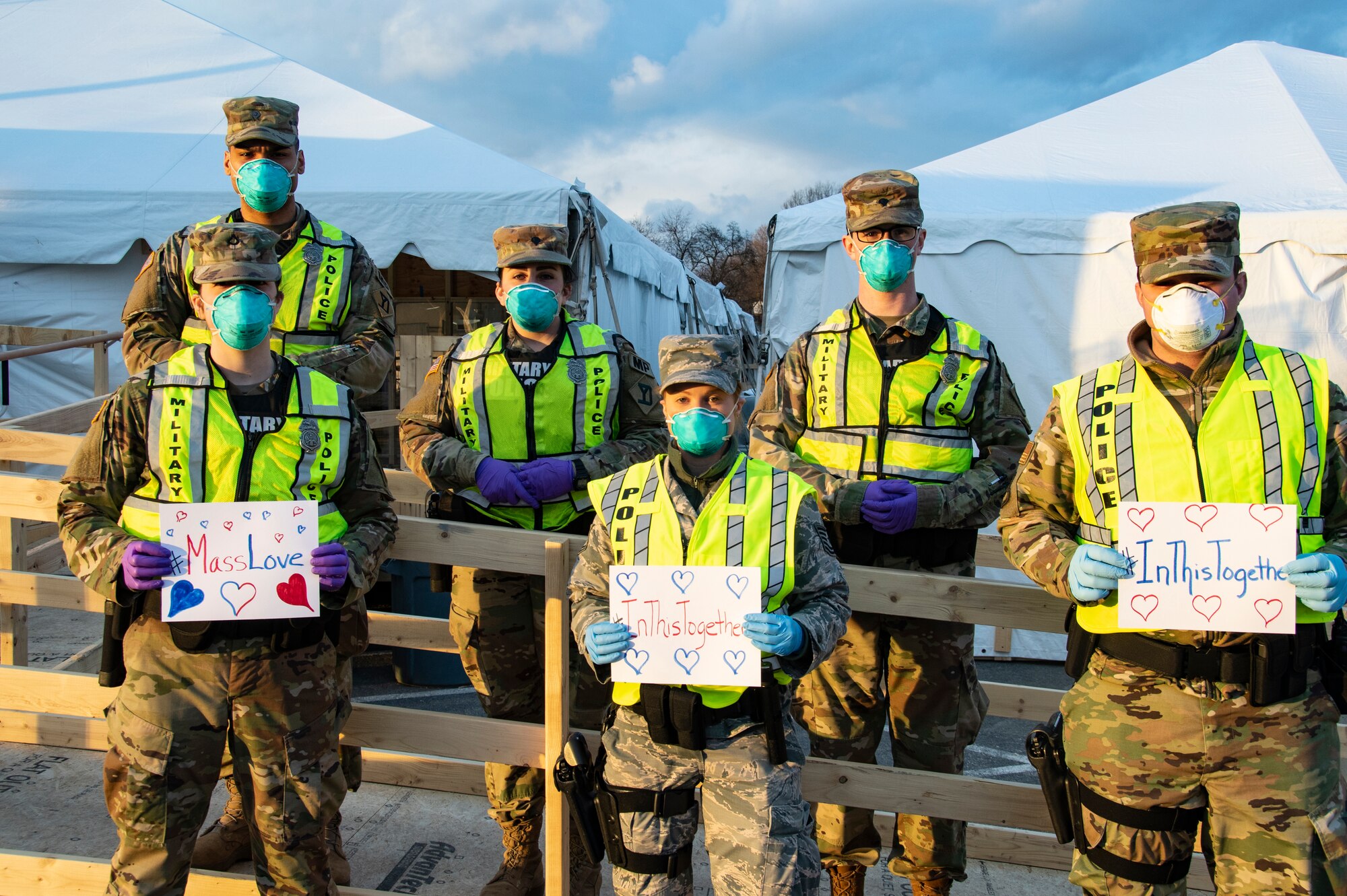 Airmen and Soldiers of the Massachusetts National Guard take a photo they respond together to help their communities during the COVID-19 response. Security Forces Airmen from the 104th Fighter Wing, Barnes Air National Guard Base, Mass., and Soldiers with the 747th Military Police Company, Massachusetts Army National Guard, are providing 24-hour security for testing sites and shelters for the homeless who may be positive COVID-19. The Airmen and Soldiers are working with interagency partners Springfield Police Department to ensure security and safety for the supplies, patients, and staff. Massachusetts National Guard units were activated at the request of Governor Charlie Baker and are helping at the testing facilities as a joint-task force. (Left to Right: Spc. Haley MacDonald and Spc. Alan Navarro) (U.S. Air National Guard Photo by Senior Master Sgt. Julie Avey)