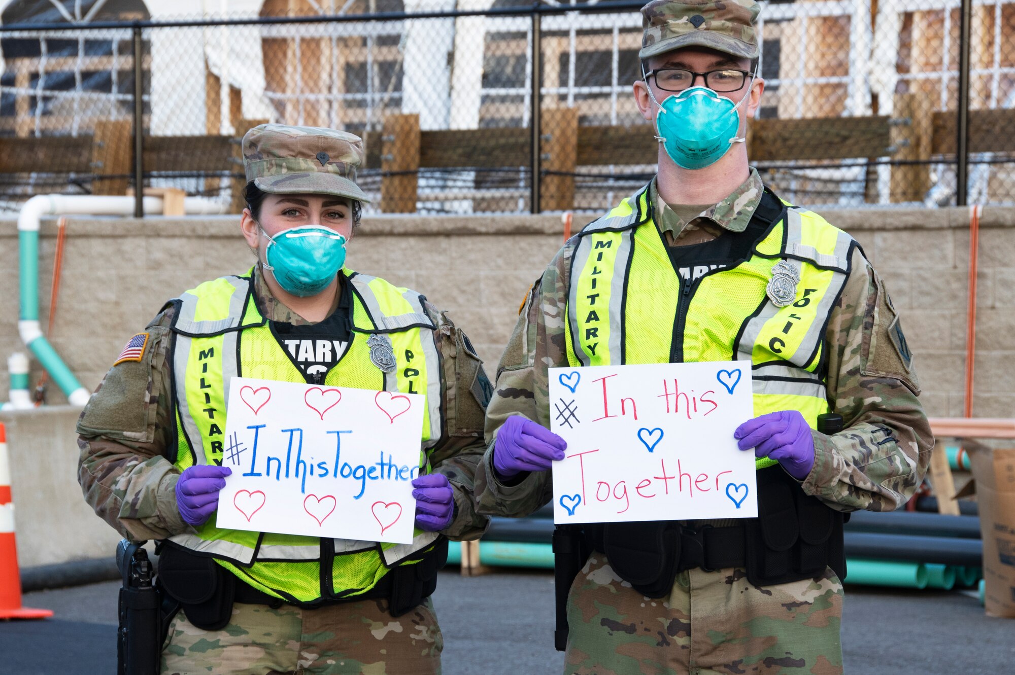 Airmen and Soldiers of the Massachusetts National Guard take a photo they respond together to help their communities during the COVID-19 response. Security Forces Airmen from the 104th Fighter Wing, Barnes Air National Guard Base, Mass., and Soldiers with the 747th Military Police Company, Massachusetts Army National Guard, are providing 24-hour security for testing sites and shelters for the homeless who may be positive COVID-19. The Airmen and Soldiers are working with interagency partners Springfield Police Department to ensure security and safety for the supplies, patients, and staff. Massachusetts National Guard units were activated at the request of Governor Charlie Baker and are helping at the testing facilities as a joint-task force. (Left to Right: Spc. Haley MacDonald and Spc. Alan Navarro) (U.S. Air National Guard Photo by Senior Master Sgt. Julie Avey)