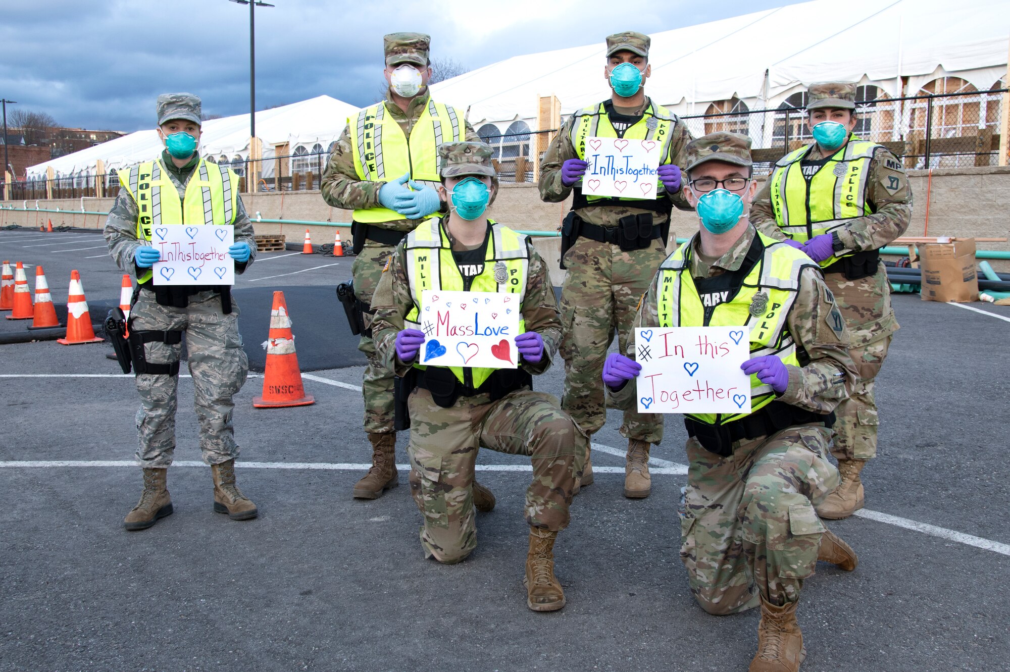 Airmen and Soldiers of the Massachusetts National Guard take a photo they respond together to help their communities during the COVID-19 response. Security Forces Airmen from the 104th Fighter Wing, Barnes Air National Guard Base, Mass., and Soldiers with the 747th Military Police Company, Massachusetts Army National Guard, are providing 24-hour security for testing sites and shelters for the homeless who may be positive COVID-19. The Airmen and Soldiers are working with interagency partners Springfield Police Department to ensure security and safety for the supplies, patients, and staff. Massachusetts National Guard units were activated at the request of Governor Charlie Baker and are helping at the testing facilities as a joint-task force. (Left to Right back row: Tech. Sgt. Shomeret Chevalier, Airman Stephen Jeffers, Pfc. Alan Navarro, and Spc. Haley MacDonald Left to Right Front Row: Pfc. Donovan Sawyer and Spc. Nicholas Maracle) (U.S. Air National Guard Photo by Senior Master Sgt. Julie Avey)