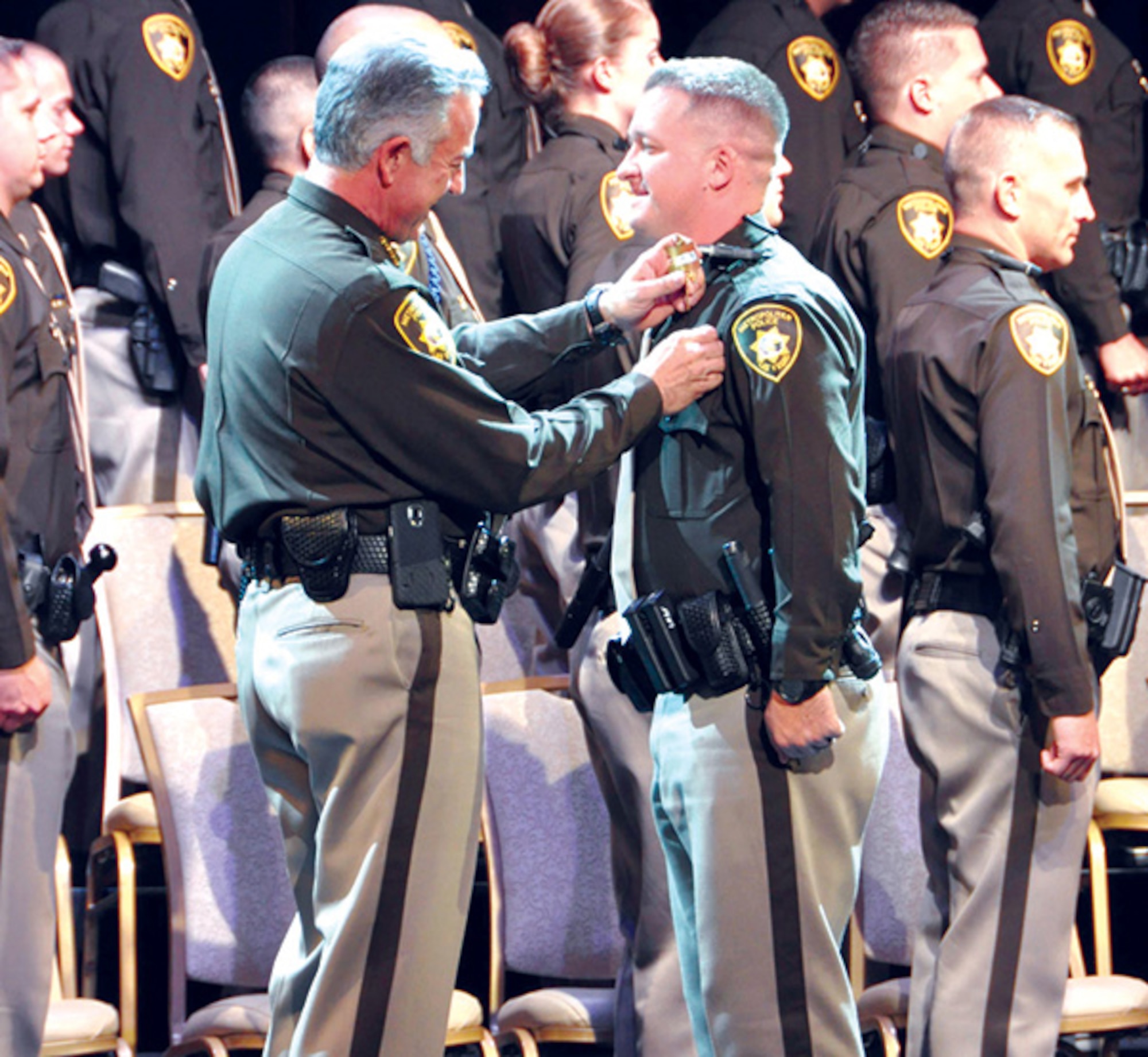 Senior Airman Brett Clashman (right), 926th Wing public affairs specialist, during his academy graduation ceremony for the Las Vegas Metropolitan Police Department. Clashman has been a commissioned peace officer with the Las Vegas Metropolitan Police Department since 2015. In his current role as an intelligence officer, he observes and analyzes crime trends, allowing him to utilize that information to help better direct resources and manpower.