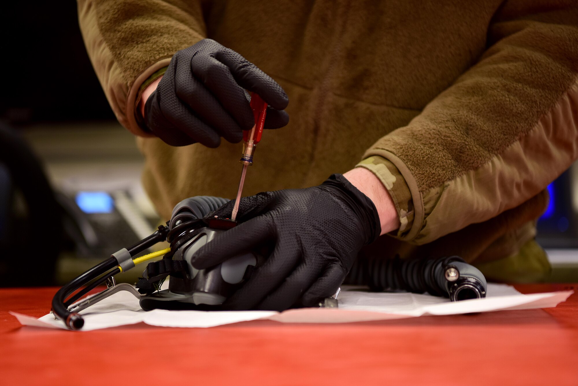 U.S. Air Force Senior Airman Alex Perry, a 354th Aircrew Flight Equipment journeyman, inspects a pilot’s oxygen mask on April 9, 2020, at Eielson Air Force Base, Alaska.