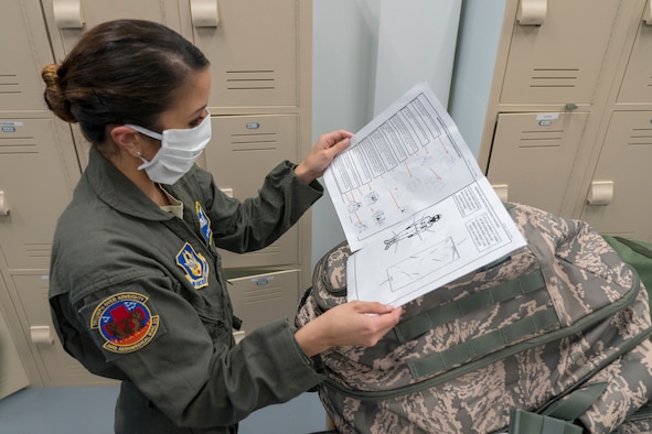 Senior Airman Emilie Canlas, 36th Aeromedical Evacuation Squadron aeromedical evacuation technician, reads over her checklist of assigned equipment April 9, 2020 at Keesler Air Force Base, Miss. The call for aeromedical support came just days after the Air Force Reserve mobilized more than 120 medical personnel across the nation to Joint Base McGuire-Dix-Lakehurst, New Jersey, to help with the fight against COVID-19 in New York City. The specific mission details of the aeromedical evacuation teams mobilizing today are still in coordination, but these Air Force Reservists can provide critical patient care at any location worldwide. (U.S. Air Force photo by Tech. Sgt. Christopher Carranza)