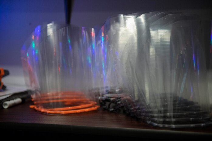 Face shields made by Senior Airman Jace Zook sit on a table.