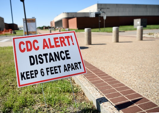 A Center of Disease Control sign stakes into the ground near the Di Tommaso Hall on Goodfellow Air Force Base, Texas, April 13, 2020.  Signs were placed around the base reminding personnel to maintain a social distance of at least six feet to limit the spread of COVID-19. The 17th Training Wing Commander declared Goodfellow a public health emergency and limited base access to mission essential personnel.  (U.S. Air Force Airman 1st Class Abbey Rieves)