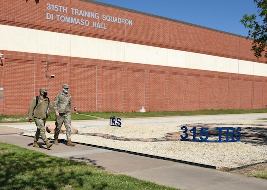 U.S. Air Force Airmen from the 315th Training Squadron, wear masks while leaving Di Tommaso Hall on Goodfellow Air Force Base, Texas, 2020. Goodfellow members were directed under the Department of Defense to wear cloth face coverings when members couldn’t maintain six feet of social distance in public areas or work centers during the COVID-19 pandemic.  The DoD implemented necessary measures to mitigate the spread of the disease and safeguard national security capabilities. (U.S. Air Force Airman 1st Class Abbey Rieves)
