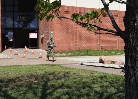 U.S. Air Force mission essential Airman from the 315th Training Squadron, leaves Di Tommaso Hall wearing a handmade mask on Goodfellow Air Force Base, Texas April 13, 2020. The installation limited base access to mission essential individuals, such as instructors and students, to eliminate the spread of COVID-19. Goodfellow members were directed under the Department of Defense to wear cloth face coverings when members couldn’t maintain six feet of social distance in public areas or work centers.   (U.S. Air Force Airman 1st Class Abbey Rieves)