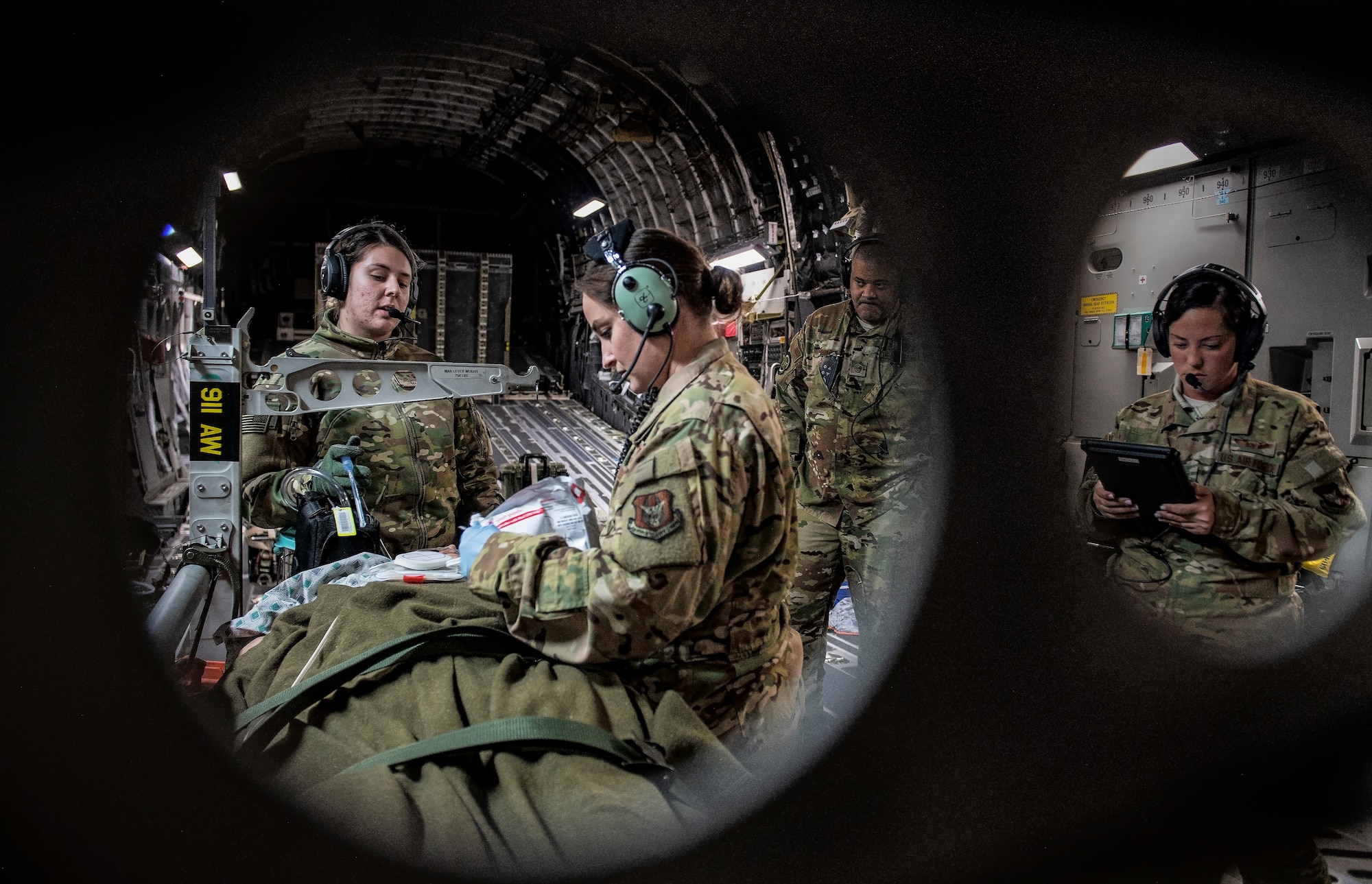 Air Force Reserve Aeromedical Evacuation personnel check on a simulated patient.