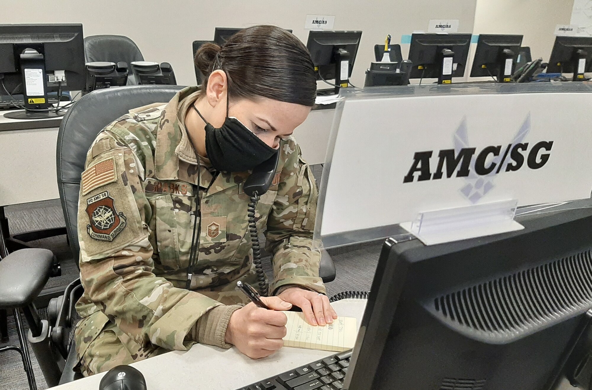 Master Sgt. Melissa Sparks, Air Mobility Command Commander’s Battle Staff SG or medical representative, coordinates daily operations from the CBS in support of the fight against the COVID-19 pandemic at Scott Air Force Base, Illinois, April 15, 2020. Since its activation March 4, 2020, the AMC CBS has served as a single, 24/7 cell of experts to ensure uninterrupted rapid global mobility amidst the COVID-19 pandemic, producing more than 40 Battle Staff Directives to guide Airmen on everything from aircraft decontamination to patient movement to timely reporting of COVID-19 cases at AMC installations. (U.S. Air Force photo by Col. Damien Pickart)
