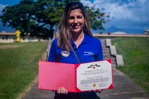 Kimberly McNally, community health nurse, Marine Corps Base Hawaii, poses with her Civilian Service Achivement Award certificate for impactful achievement while serving as community health nurse, MCBH, Apr. 15, 2020. Over the past sixty days, McNally consistently performed her demanding duties in an exemplary and highly professional manner in accomplishing the mission as a community health nurse during the COVID-19 outbreak. (U.S. Marine Corps photo by Cpl. Matthew Kirk)