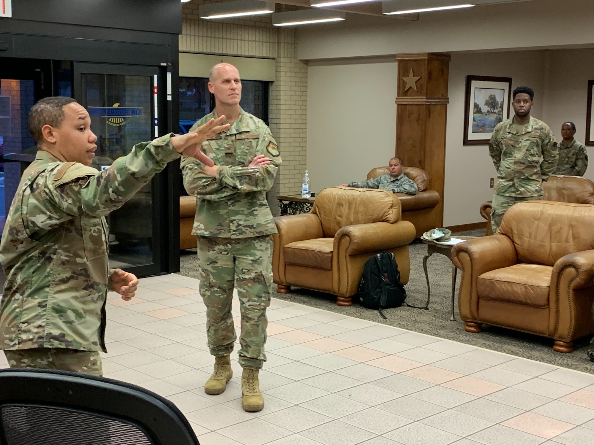 U.S. Air Force Col. Steven Anderson, 688th Cyberspace Wing commander receives a charge of quarters briefing from Master Sgt. Stephanie Russ, 323rd Training Squadron. Col. Anderson and a team of Airmen volunteered for CQ duty in support of Basic Military Training Airmen overnight Tuesday, April 7, 2020, Joint Base San Antonio – Lackland, Texas.  CQ duties include intake, tracking and reporting, wellness checks, meal and personal item delivery, and arranging transport upon release.  (U.S. Air Force photo by Chief Master Sgt. Israel Jaeger)