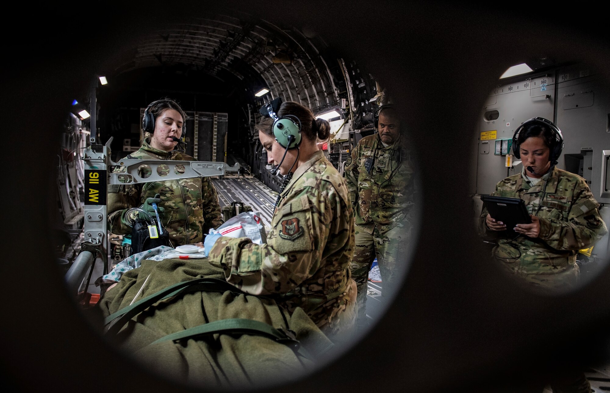 Air Force Reserve Aeromedical Evacuation personnel check on a simulated patient.