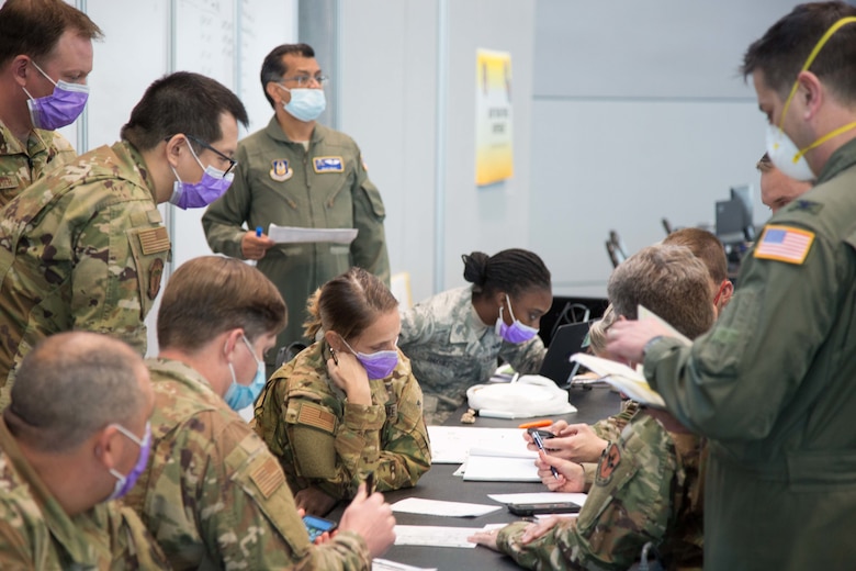 U.S. Air Force medical providers, assigned to the Javits New York Medical Station (JNYMS), discuss task force personnel capability to augment local hospitals as part of the COVID-19 response effort, April 7, 2020. The 621st Mobility Support Operations Squadron AMLOs provided airlift support to U.S. Army North to move soldiers into field hospital units in COVID-19 hotspots. (U.S. Army Photo by Sgt. Deonte Rowell)