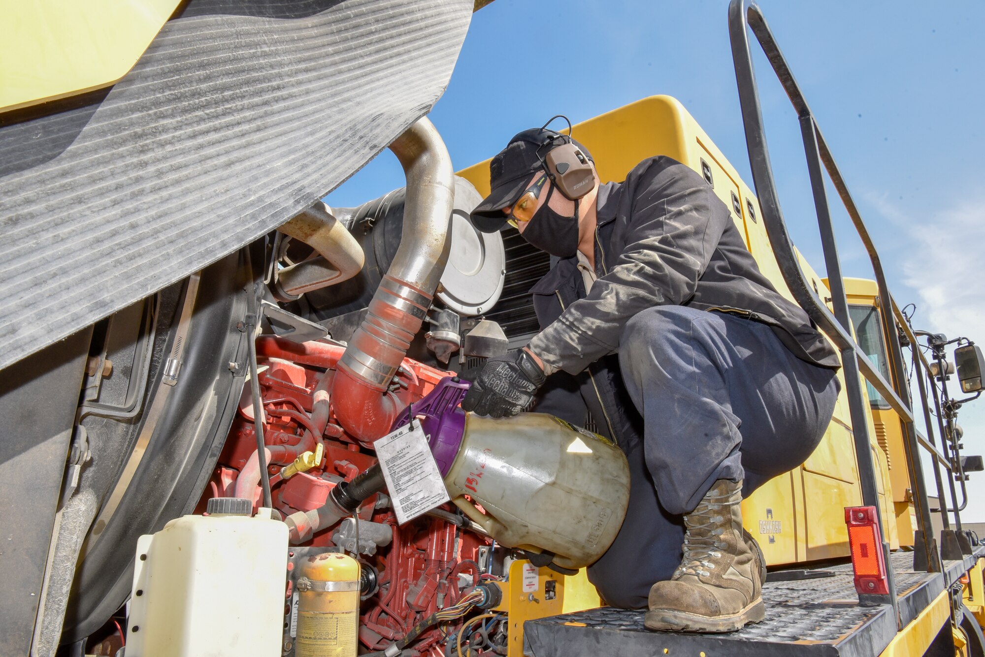 U.S. Air Force Senior Airman Michael Delgado, 8th Logistics Readiness Squadron vehicle maintenance firetruck and refueling maintenance technician, replenishes the engine oil in a mission critical vehicle at Kunsan Air Base, Republic of Korea, April 14, 2020. Delgado is one of 48 vehicle maintenance Airmen working to maintain a fleet of over 500 vehicles. (U.S. Air Force photo by Tech. Sgt. Joshua Arends)
