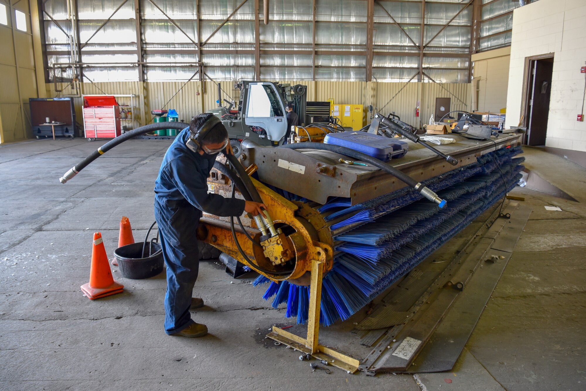 U. S. Air Force Staff Sgt. Michael Natan, 8th Logistics Readiness Squadron vehicle maintenance seasonal equipment maintenance assistant NCO in charge,  repairs a street sweeper at Kunsan Air Base, Republic of Korea, April 14, 2020. Vehicles such as the street sweeper perform mission critical services such as keeping flight lines free of debris and ensuring the safety of the flying mission. (U.S. Air Force photo by Tech. Sgt. Joshua Arends)
