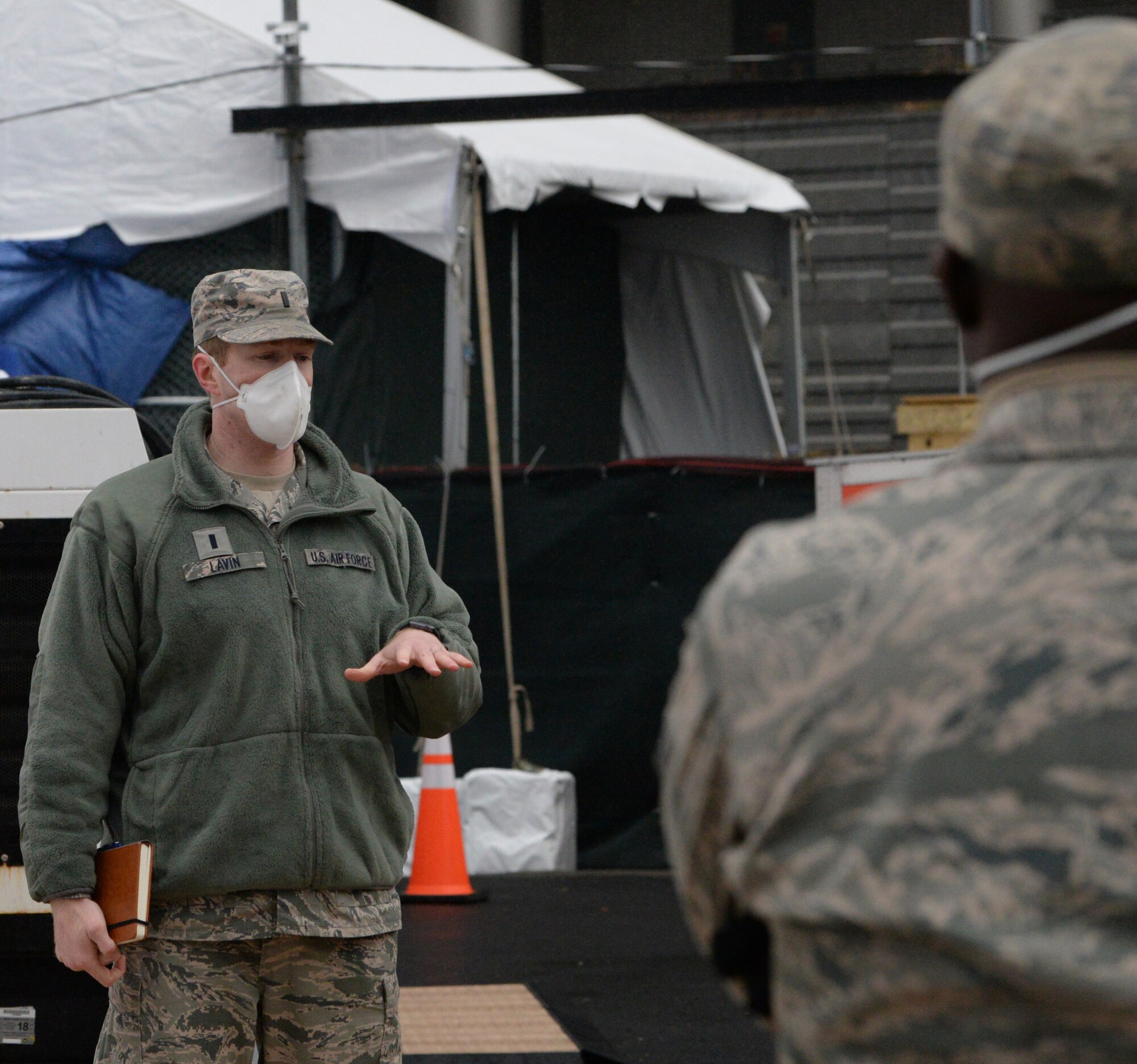 1st Lt. Shawn Lavin of Amherst, N.Y., the commander of the  New York Air National Guard's 107th Attack Wing Fatality Search and Recovery Team, gives a morning briefing outside Bellevue Hospital in New York City, April 4, 2020. The New York National Guard members are supporting the Office of the Chief Medical Examiner to locate and conduct dignified retrieval of remains.