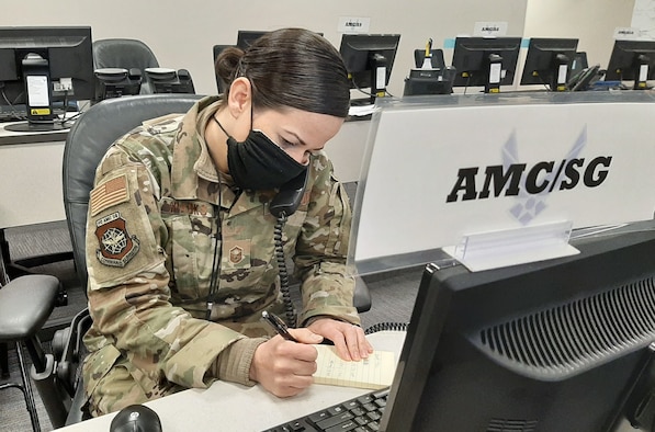 Master Sgt. Melissa Sparks, Air Mobility Command Commander’s Battle Staff SG or medical representative, coordinates daily operations from the CBS in support of the fight against the COVID-19 pandemic at Scott Air Force Base, Illinois, April 15, 2020. Since its activation March 4, 2020, the AMC CBS has served as a single, 24/7 cell of experts to ensure uninterrupted rapid global mobility amidst the COVID-19 pandemic, producing more than 40 Battle Staff Directives to guide Airmen on everything from aircraft decontamination to patient movement to timely reporting of COVID-19 cases at AMC installations. (U.S. Air Force photo by Col. Damien Pickart)